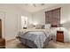 Bedroom featuring neutral carpet, a ceiling fan, and a comfortable-looking bed with decorative pillows at 9231 W Bent Tree Dr, Peoria, AZ 85383
