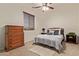 Cozy bedroom featuring wood furniture, plush bedding, and natural light at 9231 W Bent Tree Dr, Peoria, AZ 85383