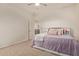 Bedroom featuring neutral carpet, a ceiling fan, and a comfortable-looking bed with decorative pillows at 9231 W Bent Tree Dr, Peoria, AZ 85383