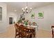 Open dining room showcasing neutral walls, tile floors, chandelier, and staircase at 9231 W Bent Tree Dr, Peoria, AZ 85383