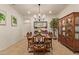 Formal dining area featuring a piano, wooden table, and elegant chandelier lighting at 9231 W Bent Tree Dr, Peoria, AZ 85383