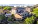 View of the home's exterior featuring owned solar panels, patio with sunshade, and a well maintained backyard at 9231 W Bent Tree Dr, Peoria, AZ 85383