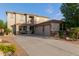 Spacious home featuring a three-car garage, desert landscaping, and welcoming front porch at 9231 W Bent Tree Dr, Peoria, AZ 85383