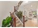 Elegant foyer with a staircase featuring decorative iron railings and tiled flooring at 9231 W Bent Tree Dr, Peoria, AZ 85383