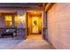 Inviting front entrance with decorative wreath, covered porch, and view of the three-car garage at 9231 W Bent Tree Dr, Peoria, AZ 85383