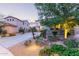 Beautifully landscaped front yard with mature trees, rocks, and desert plants creating a serene setting at 9231 W Bent Tree Dr, Peoria, AZ 85383