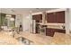 Kitchen showcases granite countertops, stainless steel appliances, rich wood cabinetry, and an open layout for easy entertaining at 9231 W Bent Tree Dr, Peoria, AZ 85383