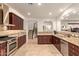Gourmet kitchen has granite counters, tile backsplash, stainless appliances and easy access to the staircase at 9231 W Bent Tree Dr, Peoria, AZ 85383