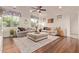 Open living room featuring hardwood floors, plush sofa, and a neutral palette at 9231 W Bent Tree Dr, Peoria, AZ 85383