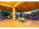 Inviting covered patio with comfortable seating, lush landscaping, and a charming water feature at 9231 W Bent Tree Dr, Peoria, AZ 85383