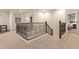 A carpeted upstairs hall showing the wrought iron staircase railing at 9231 W Bent Tree Dr, Peoria, AZ 85383
