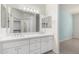 Bright bathroom with double sinks, large mirror and a walk-in closet access at 9550 E Thunderbird Rd # 259, Scottsdale, AZ 85260