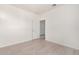 Bright bedroom with white walls, wood-style floors, and a door to another room at 9550 E Thunderbird Rd # 259, Scottsdale, AZ 85260