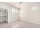 Bright bedroom with white walls, wood-style floors, and an open closet space at 9550 E Thunderbird Rd # 259, Scottsdale, AZ 85260