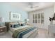 Relaxing bedroom featuring a queen bed, cool paint, white plantation shutters, and neutral decor at 9550 E Thunderbird Rd # 259, Scottsdale, AZ 85260