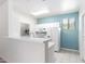Kitchen featuring white cabinets, appliances, and a breakfast bar with stylish countertops at 9550 E Thunderbird Rd # 259, Scottsdale, AZ 85260