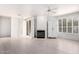 Bright and airy living room with white hardwood floors and a cozy fireplace at 9550 E Thunderbird Rd # 259, Scottsdale, AZ 85260