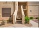 Exterior stairway leading to units with desert landscaping surrounding the walkway at 9550 E Thunderbird Rd # 259, Scottsdale, AZ 85260