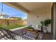 Relaxing covered back patio with comfortable seating, a rug, and backyard views at 9570 W Whispering Wind Dr, Peoria, AZ 85383