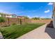 Backyard view featuring a putting green, artificial grass, and a paver pathway at 9570 W Whispering Wind Dr, Peoria, AZ 85383