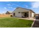 Backyard featuring a putting green, artificial grass, patio and covered patio at 9570 W Whispering Wind Dr, Peoria, AZ 85383