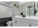 Bright bathroom featuring a double sink vanity, modern fixtures, and a decorative mirror at 9570 W Whispering Wind Dr, Peoria, AZ 85383