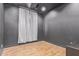 Charming bedroom featuring wood-look flooring, a fan, and dark gray walls at 9570 W Whispering Wind Dr, Peoria, AZ 85383