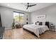 Comfortable bedroom with a large window, stylish decor, and wood-look floors at 9570 W Whispering Wind Dr, Peoria, AZ 85383