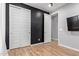 This bedroom features modern sliding closet doors, wood-look floors, and grey walls at 9570 W Whispering Wind Dr, Peoria, AZ 85383