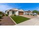 Charming single-story home featuring desert landscaping, a 2-car garage and brick paver driveway at 9570 W Whispering Wind Dr, Peoria, AZ 85383
