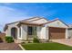 Charming home featuring a well-manicured lawn, desert landscaping, and a tile roof at 9570 W Whispering Wind Dr, Peoria, AZ 85383