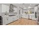 Modern kitchen features white cabinets, stainless steel appliances, and an open concept layout at 9570 W Whispering Wind Dr, Peoria, AZ 85383