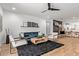 Open concept living room and dining area with modern decor and a view into the kitchen at 9570 W Whispering Wind Dr, Peoria, AZ 85383