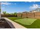 Backyard with putting green, artificial turf and landscaping at 9570 W Whispering Wind Dr, Peoria, AZ 85383