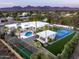Expansive estate featuring a pool, tennis court, basketball court, and cabana, all set against a mountain backdrop at 9733 E Clinton St, Scottsdale, AZ 85260