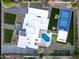 This estate has a pool, tennis court, and basketball court surrounded by landscaped grounds and a modern white house at 9733 E Clinton St, Scottsdale, AZ 85260