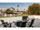 Cozy backyard with a modern fire pit, comfortable seating, and desert landscaping at 9733 E Clinton St, Scottsdale, AZ 85260