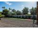 Backyard batting cage featuring artificial turf and gravel landscaping surrounded by a white brick fence at 9733 E Clinton St, Scottsdale, AZ 85260
