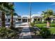 A private backyard oasis showcasing a sparkling pool, lush lawn, and meticulously landscaped garden with palm trees at 9733 E Clinton St, Scottsdale, AZ 85260