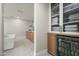 Bathroom area featuring a soaking tub, wooden cabinets, and a mini fridge at 9733 E Clinton St, Scottsdale, AZ 85260