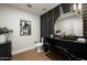 Modern bathroom featuring black marble countertops, a gold mirror, and unique decor at 9733 E Clinton St, Scottsdale, AZ 85260