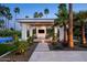 Elegant cabana featuring stylish furniture and a TV, surrounded by lush, manicured greenery at 9733 E Clinton St, Scottsdale, AZ 85260