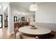 This cozy dining area features a round table, banquette seating, and seamless access to the kitchen at 9733 E Clinton St, Scottsdale, AZ 85260