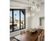 Dining area with stylish lighting, a large window, and views of the landscape at 9733 E Clinton St, Scottsdale, AZ 85260