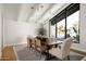 Elegant dining room with a large table, stylish seating, and natural light at 9733 E Clinton St, Scottsdale, AZ 85260