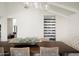 Bright dining room with a decorative centerpiece, modern lighting, and a built-in wine rack at 9733 E Clinton St, Scottsdale, AZ 85260