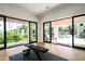 Well lit exercise room featuring floor to ceiling glass doors overlooking the outdoor pool at 9733 E Clinton St, Scottsdale, AZ 85260