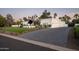 Exterior view of a modern home with manicured landscaping and a paved driveway at 9733 E Clinton St, Scottsdale, AZ 85260