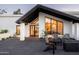 Front entrance featuring modern design, a cozy fire pit, and stylish seating at 9733 E Clinton St, Scottsdale, AZ 85260