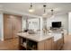 Open concept kitchen features a large island with a sink and seating at 9733 E Clinton St, Scottsdale, AZ 85260